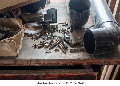 bolts and screws and all sorts of old junk on a dusty wooden table in the garage. copy space.
