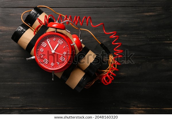 Bomb with clock\
timer on wooden background