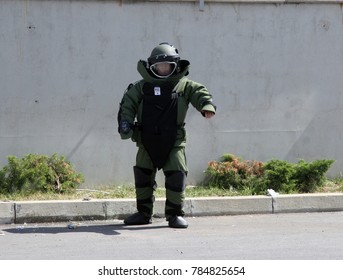 A bomb disposal agent in a bomb suit disarm a bomb inside a car of terrorists during military training in the city of Sofia, Bulgaria on Sep,11, 2007. Bomb squad robot