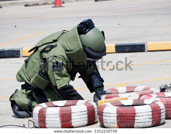 Bomb Disposal Expert in Bomb suit for Explosive\
ordnance disposal
