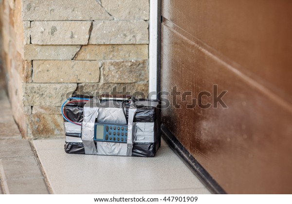 bomb with\
radio control and digital countdown timer near the garage door.\
terrorism and dangerous life\
concept