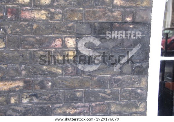 A bomb shelter sign from World\
War II on a wall in Lord North Street in Westminster, London,\
UK