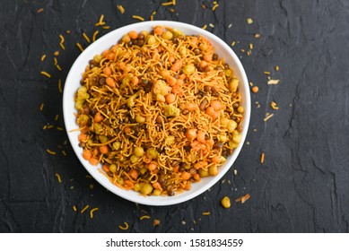 
Bombay mix or Chiwda on dark black background. Spicy  Mixture  Kerala tea time snacks fried  in coconut oil. - Shutterstock ID 1581834559