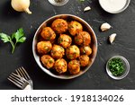 Bombay potatoes. Pan fried little baby potatoes with jeera seeds and coriander in bowl over dark background. Popular indian dish. Top view, flat lay