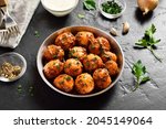 Bombay potatoes. Pan fried little baby potatoes with jeera seeds and coriander in bowl over dark background. Popular indian dish. 