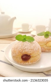 Bomboloni Is A Type Of Donut That Has A Filling Inside, With The Outside Usually Just Sprinkled With Powdered Sugar.