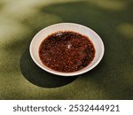 Bon Chilies Mixed with Soy Aauce in a Small Qhite Plate, Seasoning When Eating Sushi