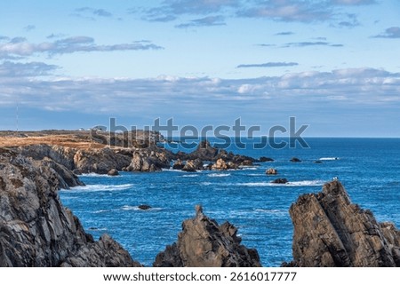 Bonavista, Newfoundland, Canada. Dungeon Provincial Park UNESCO Geosite. Blue sky, clouds. Dungeon Road Beach, the jaggy coast. Tourist attractions, geological wonders. 