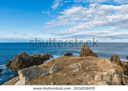 Bonavista, Newfoundland, Canada. Dungeon Provincial Park UNESCO Geosite. Blue sky, clouds. Dungeon Road Beach, the jaggy coast. Tourist attractions, geological wonders. 