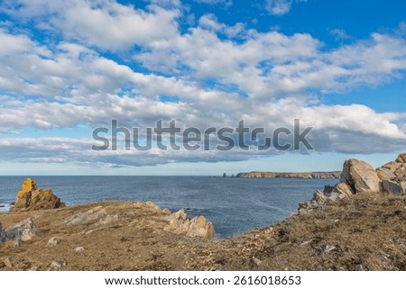 Bonavista, Newfoundland, Canada. Dungeon Provincial Park UNESCO Geosite. Blue sky, clouds. Dungeon Road Beach, the jaggy coast. Tourist attractions, geological wonders. 