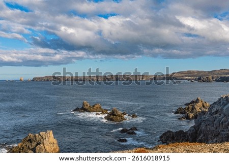 Bonavista, Newfoundland, Canada. Dungeon Provincial Park UNESCO Geosite. Blue sky, clouds. Dungeon Road Beach, the jaggy coast. Tourist attractions, geological wonders. 