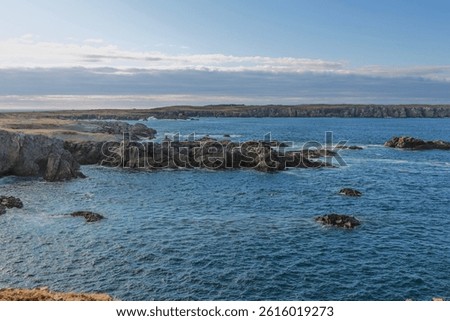 Bonavista, Newfoundland, Canada. Dungeon Provincial Park UNESCO Geosite. Blue sky, clouds. Dungeon Road Beach, the jaggy coast. Tourist attractions, geological wonders. 