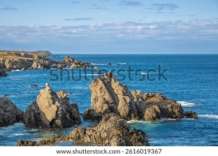 Bonavista, Newfoundland, Canada. Dungeon Provincial Park UNESCO Geosite. Blue sky, clouds. Dungeon Road Beach, the jaggy coast. Tourist attractions, geological wonders. 