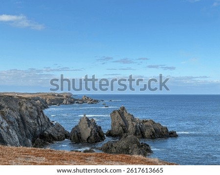 Bonavista, Newfoundland, Canada. Dungeon Provincial Park UNESCO Geosite. Blue sky, clouds. Dungeon Road Beach, the jaggy coast. Tourist attractions, geological wonders. 