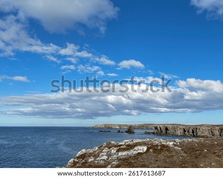 Bonavista, Newfoundland, Canada. Dungeon Provincial Park UNESCO Geosite. Blue sky, clouds. Dungeon Road Beach, the jaggy coast. Tourist attractions, geological wonders. 