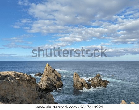 Bonavista, Newfoundland, Canada. Dungeon Provincial Park UNESCO Geosite. Blue sky, clouds. Dungeon Road Beach, the jaggy coast. Tourist attractions, geological wonders. 
