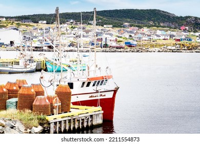 Bonavista Newfoundland Canada, September 23 2022: Fishing Boats Moored In A Harbour On The East Coast Of The Maritimes With Crab Traps And Lobster Traps On A Dock.