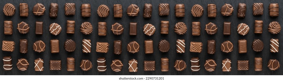 Bonbon Chocolate Pralines Texture Background, Cocoa Candies Banner, Chocolate Praline on Black with Copy Space Top View