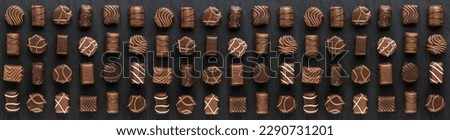 Bonbon Chocolate Pralines Texture Background, Cocoa Candies Banner, Chocolate Praline on Black with Copy Space Top View