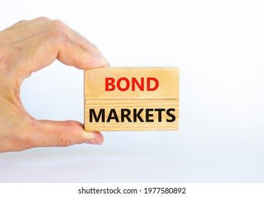 Bond markets symbol. Wooden blocks with words 'Bond markets' on beautiful white background, copy space. Businessman hand. Business and bond markets concept. - Shutterstock ID 1977580892
