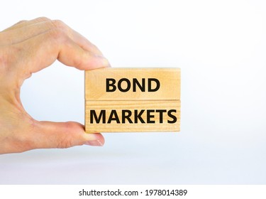 Bond markets symbol. Wooden blocks with words 'Bond markets' on beautiful white background, copy space. Businessman hand. Business and bond markets concept. - Shutterstock ID 1978014389