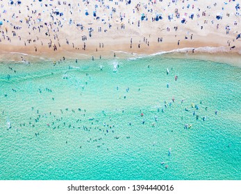 Bondi Beach aerial view on a perfect summer day with people swimming and sunbathing. Bondi is one of Sydney’s busiest beaches and is located on the East Coast of Australia - Powered by Shutterstock