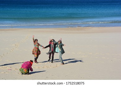 Bondi Beach, Australia-July 2019; Beach And Ocean View Of A Group Of Asian People Jumping On The Beach To Make A Photograph