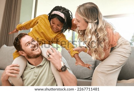 Bonding, diversity and child with parents in foster care for love, happy and safety in a family home. Playful, smile and father, mother and African girl playing in an interracial house after adoption