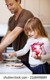 Bonding Over Breakfast. A Little Girl Making Breakfast With Her Father.