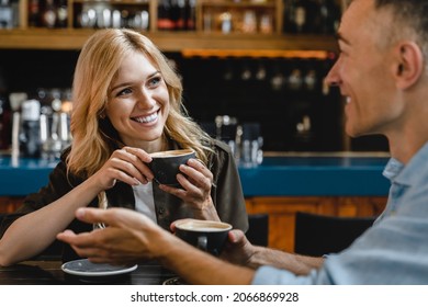 Bonding relationship. Interested excited falling in love mature woman listening to her husband man boyfriend while drinking coffee in restaurant cafe on a date - Shutterstock ID 2066869928