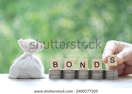 Bonds word on stack of coins money and a bag on natural green background, Investments and Bonds increasing concept