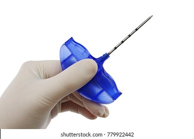 Bone Marrow Biopsy Needle Held In Doctor Left Hand In Sterile Powdered Latex Glove, White Background