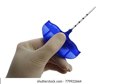 Bone Marrow Biopsy Needle Held In Doctor Left Hand In Sterile Powdered Latex Glove, White Background