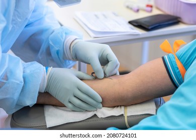 Bone Marrow Donation. Blood Transfusion. Hand In Medical Glove Injects Needle, Blood Sampling From A Vein. Intravenous Medication