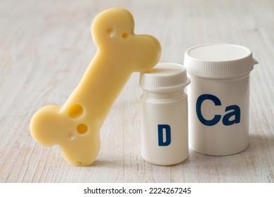 Bone shaped cheese and dietary supplements with calcium and vitamin D, strong and healthy bones concept - Shutterstock ID 2224267245