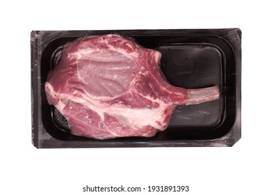 Bone Steak In Vacuum Commercial Pack Isolated On White Background. Raw Tomahawk Pork Steak In Vacuum Airtight Pack White Isolated. Pork Bone Steak In Vacuum Package, Overhead View.