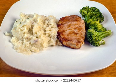 Boneless Barbecue Pork Chop Served With Broccoli And Red Mash Potatoes