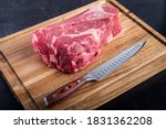 Boneless Beef Chuck Roast on a cutting board with a carving knife in the kitchen