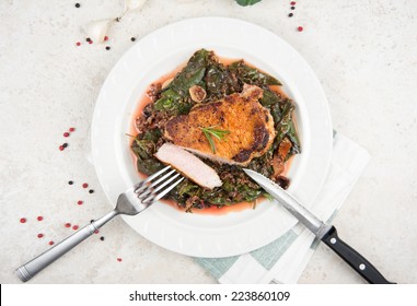 Boneless Grilled Pork Chop Served With Wilted Rainbow Chard And Collard Greens 