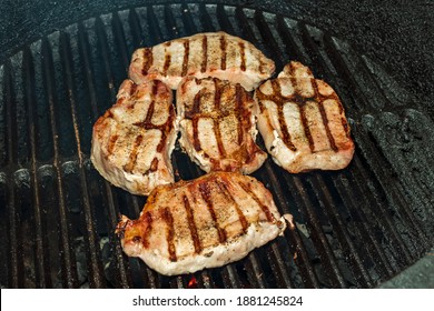 Boneless Pork Chops Cooking On A Grill For Dinner