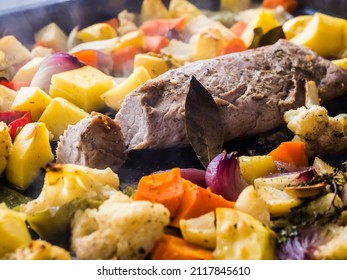 Boneless Pork Leg Cooked With Vegetables, Closeup View. Preparing Pork Leg With Vegetables And Red Wine In The Pan.