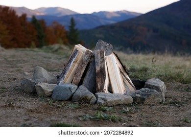 Bonfire with dry wood and stones in mountains