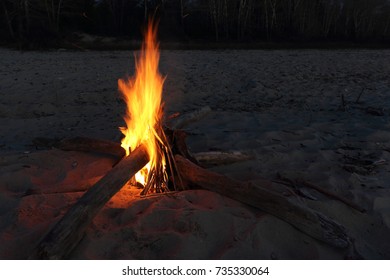 Bonfire In The Form Of Asterisk Burning On Sand