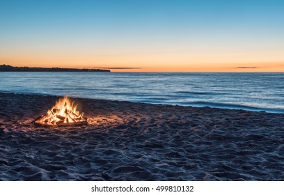 Bonfire On The Beach At Sunset