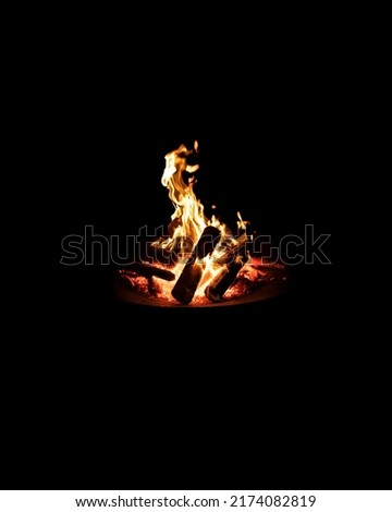 A bonfire on a pyre under the black background. Minimalism Bonfire isolated.
