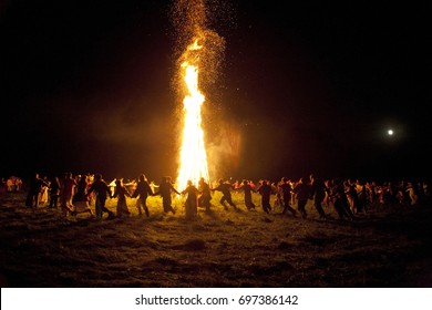 A bonfire party. solar equinox. Summer solstice. Ivan Kupala-holiday. Folk holiday of the Eastern Slavs.  The supreme flowering of nature. People dance around a huge bonfire. solar solstice