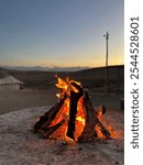 Bonfire in the Sahara desert during the sunset. 