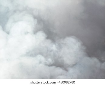 Bonfire smoke billowing into the sky creating soft fluffy background 
