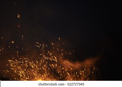 bonfire spark in the dark sky in night, shallow focus