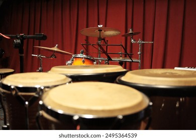 bongo drums with drum kit in the background
